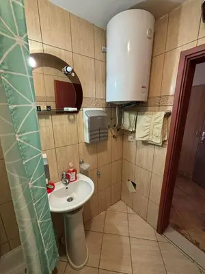 a small bathroom with a sink and a mirror at Apartment The Royal Pg in Podgorica