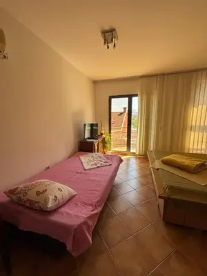 a bedroom with a bed with a pillow on it at Apartment The Royal Pg in Podgorica