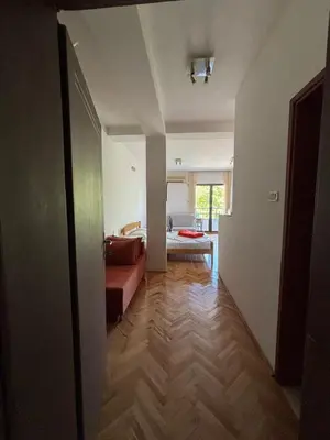 a hallway with a couch and a living room at Apartment The Royal Pg in Podgorica