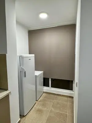 a kitchen with a refrigerator in a room at Alex Apartment in Bar
