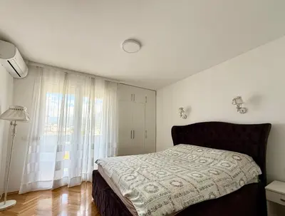a bedroom with a bed and a large window at Alex Apartment in Bar