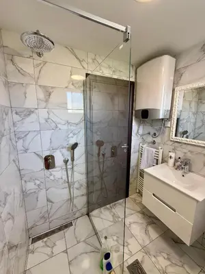 a bathroom with a shower and a sink at Alex Apartment in Bar
