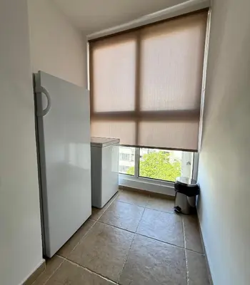 a room with a refrigerator and a window at Alex Apartment in Bar