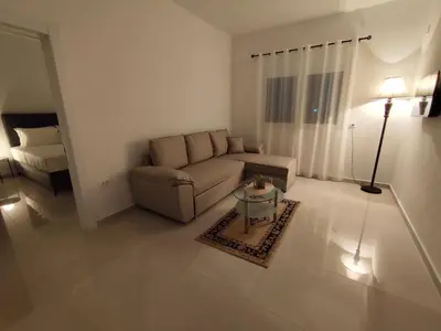 a living room with a couch and a bed at Guest House AGA in Ulcinj
