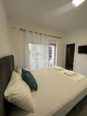 a bedroom with a large bed and a window at Guest House AGA in Ulcinj
