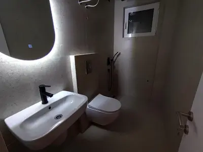 a bathroom with a sink and a toilet and a mirror at Guest House AGA in Ulcinj