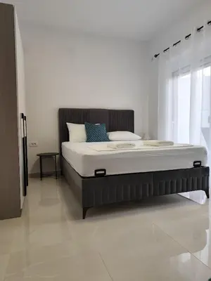 a bedroom with a large bed in a room at Guest House AGA in Ulcinj