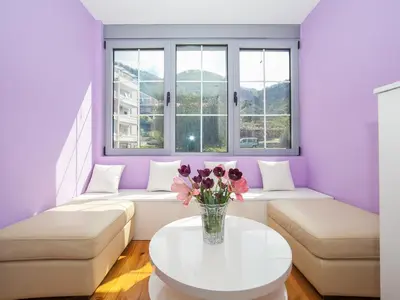 a living room with a vase of flowers on a table at Apartments Princess View in Sveti Stefan