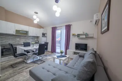 a living room with a couch and a table at Milara Apartments in Budva