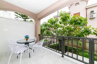 a patio with a table and chairs on a balcony at Milara Apartments in Budva