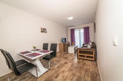 a small living room with a table and chairs at Milara Apartments in Budva