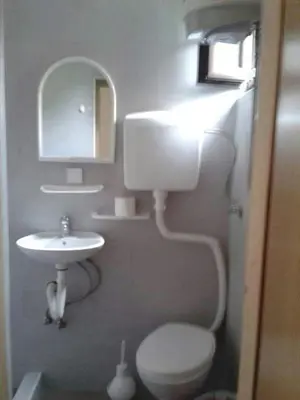 a bathroom with a toilet and a sink and a mirror at Draga`s rooms in Virpazar