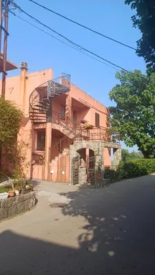 a brick building with a fire escape on it at Draga`s rooms in Virpazar