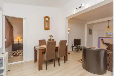 a dining room and living room with a table and chairs at Apartment Ines in Bar