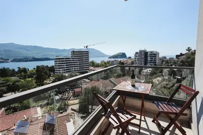 a balcony with two chairs and a table with a view at Hotel Arka in Budva