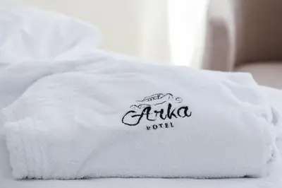 a white towel with the name of a hotel on it at Hotel Arka in Budva