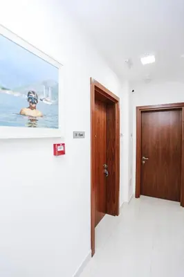a hallway with a door and a picture on the wall at Hotel Arka in Budva