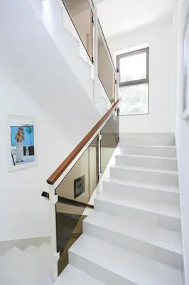 a white staircase in a house with a window at Hotel Arka in Budva