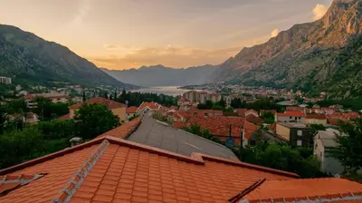 a view of a town with a river and mountains at Paradise Bay Apartments in Kotor