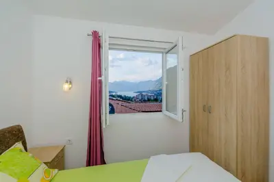 a bedroom with a window with a view at Paradise Bay Apartments in Kotor
