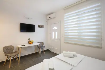 a white room with a table and chairs and a window at Apartments Dali in Budva