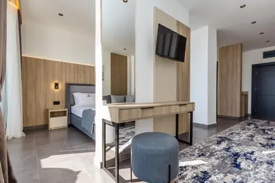 a hotel room with a bed and a tv at Continental Hotel in Ulcinj