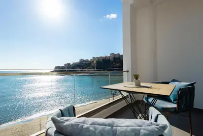 a dining room with a view of the water at Continental Hotel in Ulcinj
