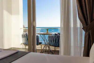 a bedroom with a bed and a view of the ocean at Continental Hotel in Ulcinj