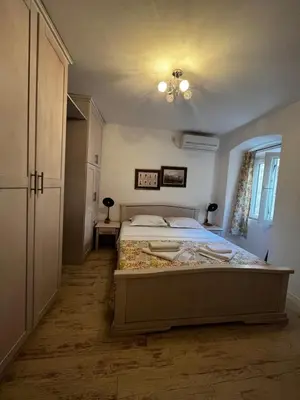 a bedroom with a large bed in a room at Athos Guesthouse in Kotor