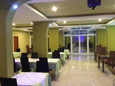 a dining room with white tables and chairs at Spa Hotel Montefila in Ulcinj