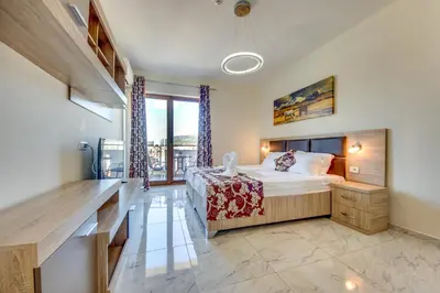 a bedroom with a bed and a large window at Spa Hotel Montefila in Ulcinj
