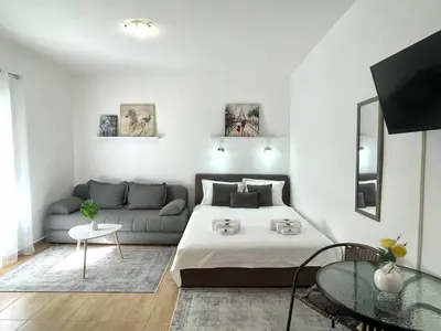 a living room with a bed and a couch at Apartments Pribilovic in Budva