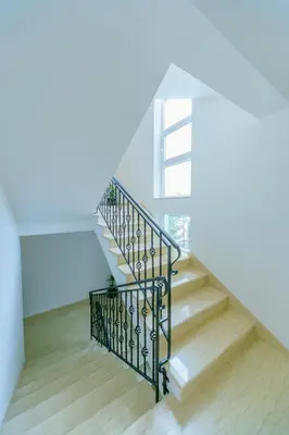 a staircase with a metal railing and wooden floors at Apartments Bujkovic in Bar
