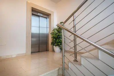 a hallway with a metal door and a potted plant at Luxury Budva Center Apartments in Budva