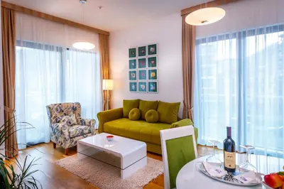 a living room with a green couch and a table at Luxury Budva Center Apartments in Budva