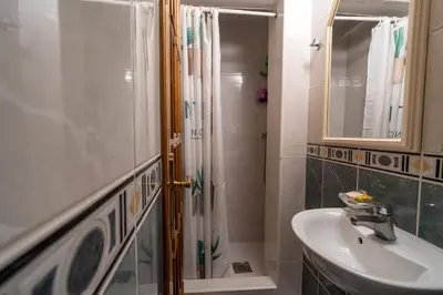 a bathroom with a sink and a shower at Studios Belvi in Kotor