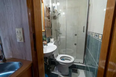 a bathroom with a toilet and a sink and a shower at Studios Belvi in Kotor