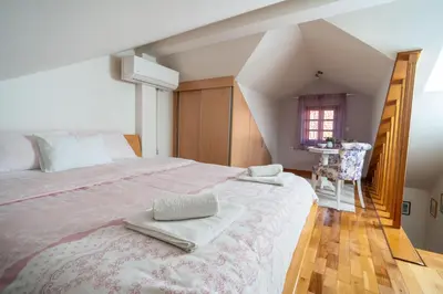 a bedroom with a large bed with two towels on it at Studios Belvi in Kotor
