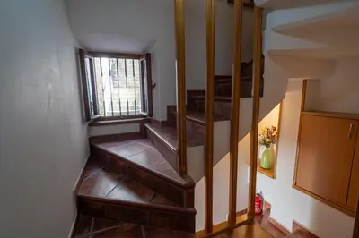 a staircase in a house with a window at Studios Belvi in Kotor