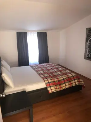 a bed in a small room with a window at D&D Budva in Budva