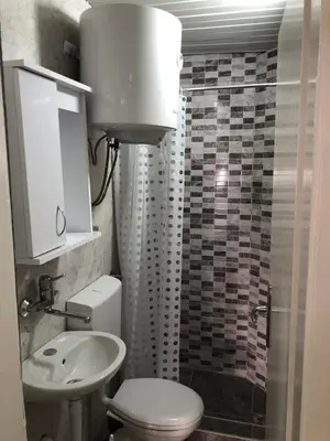 a bathroom with a white toilet and a sink at D&D Budva in Budva