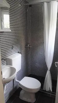 a bathroom with a toilet and a sink and a shower at D&D Budva in Budva