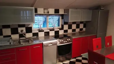 a kitchen with red cabinets and a sink at D&D Budva in Budva