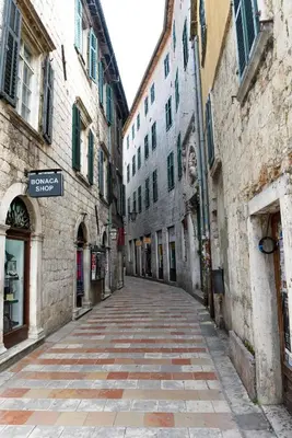 an empty street in an old town with buildings at Apartment Miguel in Kotor