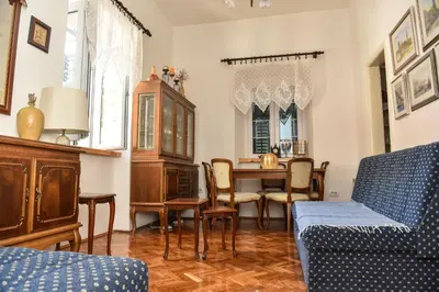 a living room with a table and chairs at Apartment Miguel in Kotor