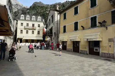 a group of people walking down a street with buildings at Apartment Miguel in Kotor