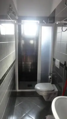 a bathroom with a toilet and a shower and a sink at Apartmani Jankovic in Budva