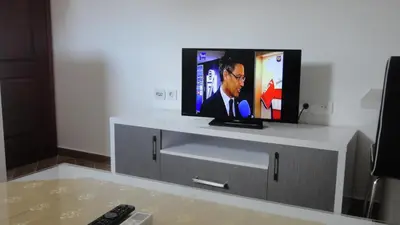 a flat screen tv sitting on top of a entertainment center at Apartmani Jankovic in Budva