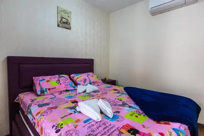 a bed with two towels on top of it at De Lux Apartments in Petrovac na Moru