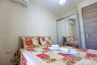 a bedroom with a bed and a mirror at De Lux Apartments in Petrovac na Moru